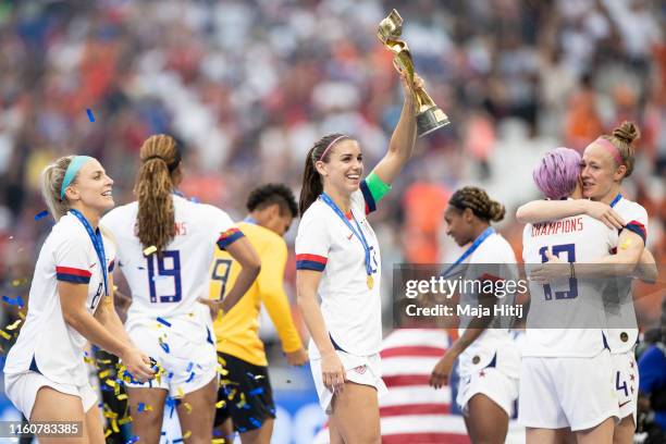 Alex Morgan and players of the USA celebrate with the trophy following the 2019 FIFA Women's World Cup France Final match between The United States...