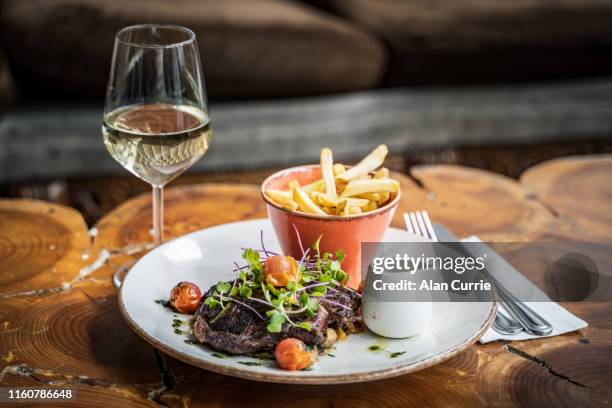 chargrilled 10oz angus ribeye steak with pepper sauce and fries - irish pub stock pictures, royalty-free photos & images