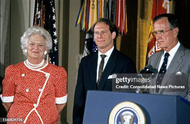 National Security Council Senior Director for Near East and South Asian Affairs Richard N Haass stands between First Lady Barbara Bush and US...