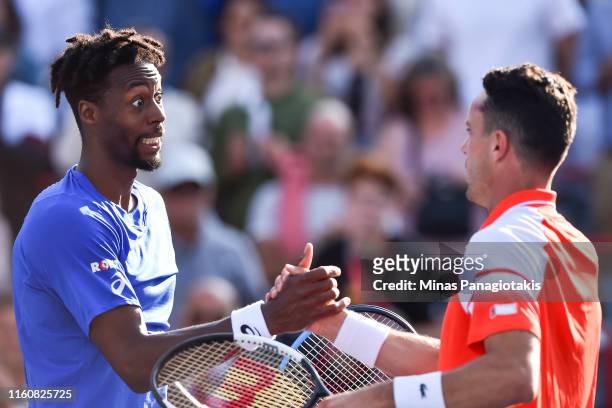 Gael Monfils of France demonstrates sportsmanship towards Roberto Bautista Agut of Spain during day 9 of the Rogers Cup at IGA Stadium on August 10,...