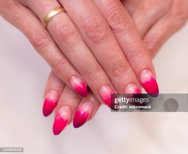 close-up of woman fingers with nail art manicure with neon colour - artificial nails stock pictures, royalty-free photos & images