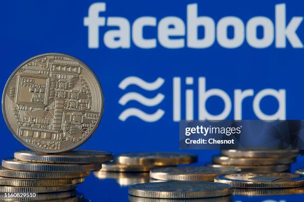 In this photo illustration, a visual representation of digital cryptocurrency coins sit on display in front of Libra and Facebook logos on July 08,...