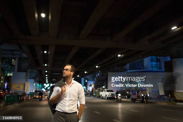 portrait of a handsome man walking at night - beauty editorial stock pictures, royalty-free photos & images