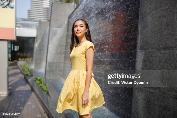 beautiful asian girl in a yellow dress - girl in yellow dress stock pictures, royalty-free photos & images