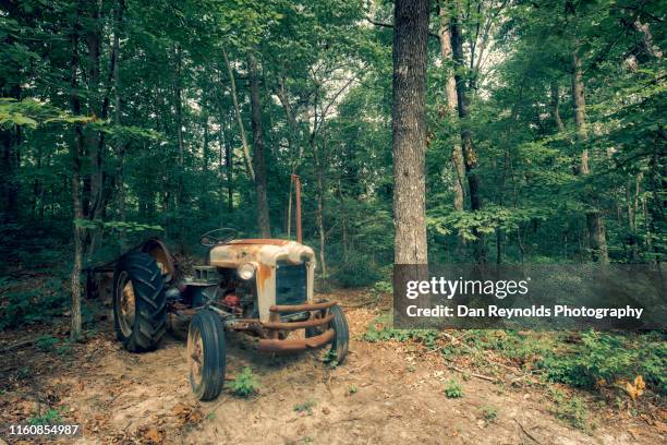 old tractor against forest backdrop - charlotte north carolina summer stock pictures, royalty-free photos & images