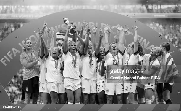 Alex Morgan of the USA lifts the FIFA Women's World Cup Trophy following her team's victory in the 2019 FIFA Women's World Cup France Final match...