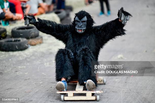 Person disguised as an ape competes during a downhill-kart racing known as "Mundialito de Rolima do Abacate" in Belo Horizonte, Brazil, on August 10,...