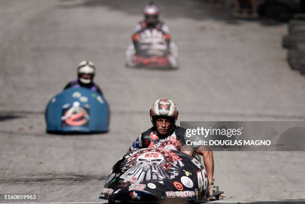 People compete during a downhill-kart racing known as "Mundialito de Rolima do Abacate" in Belo Horizonte, Brazil, on August 10, 2019.