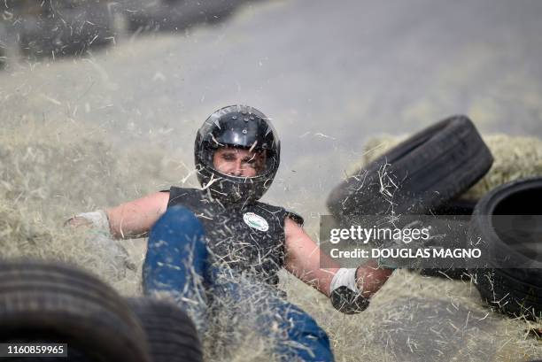 Man crashes into straw bale while competing in a downhill-kart racing known as "Mundialito de Rolima do Abacate" in Belo Horizonte, Brazil, on August...