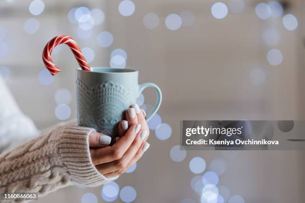 famale hands holding a cozy ceramic handmade mug with coffe. winter and christmas home time concept. lifestyle. copy space - hygge bildbanksfoton och bilder