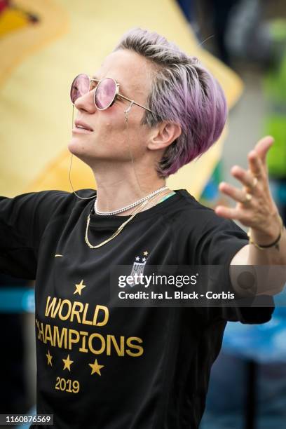 Megan Rapinoe of United States with pink dyed hair wearing a shirt that says World Champions 2019 celebrates being home and champion as the USA...