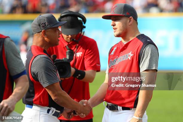 Mike Trout of the Los Angeles Angels of Anaheim and the American League speaks with manager Dave Roberts of the Los Angeles Dodgers and the National...