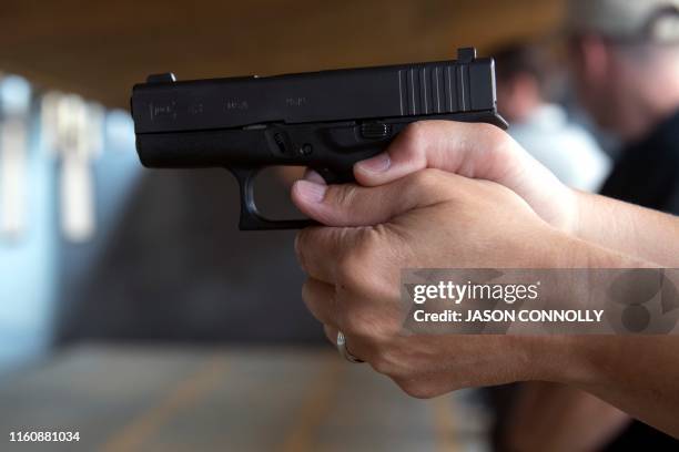 School teacher takes aim before firing his pistol during the FASTER Level 2 two day firearms course at Flatrock Training Center in Commerce City,...