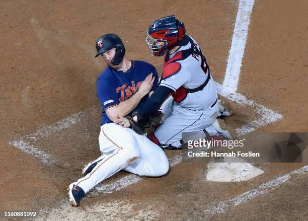 Roberto Perez of the Cleveland Indians defends home plate against C.J. Cron of the Minnesota Twins during the fourth inning of the game on August 10,...