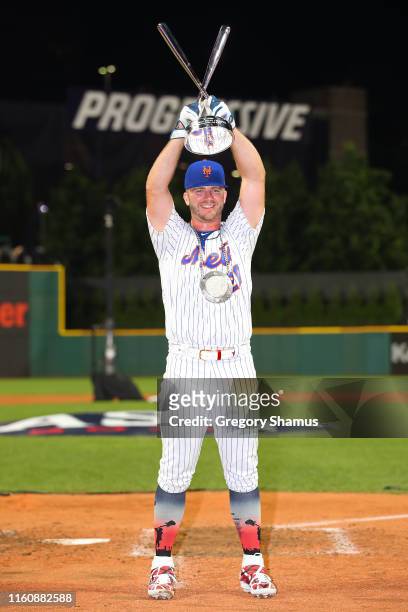 Pete Alonso of the New York Mets poses with the trophy after winning the T-Mobile Home Run Derby at Progressive Field on July 08, 2019 in Cleveland,...