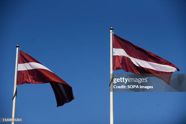 Latvians flags are seen in Riga. Riga is the capital and largest city of Latvia, one of the Baltic States countries. Located on the Gulf of Riga and...