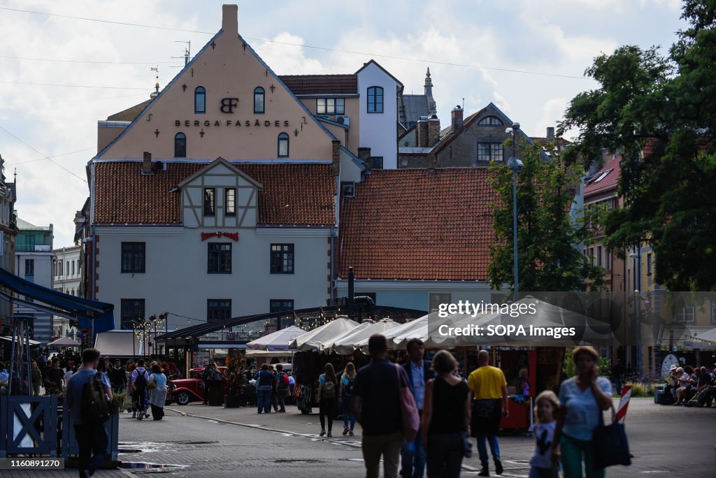 People walk past the Riga Cathedral church in the old town.