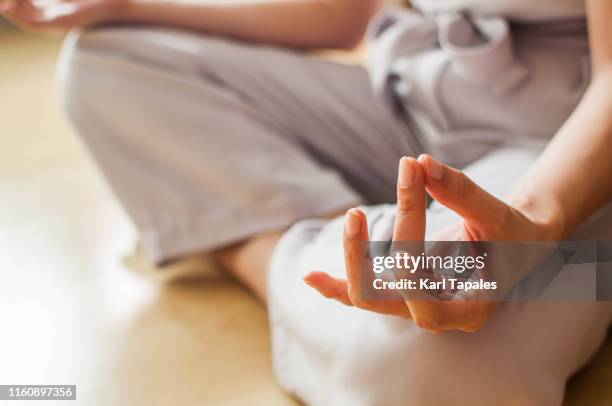 a young woman wearing office clothes is meditating indoor - office zen stock pictures, royalty-free photos & images