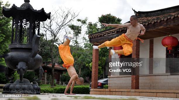 Monks practice martial art at the Quanzhou Shaolin Temple, also known as the South Shaolin Temple, on July 5, 2019 in Quanzhou, Fujian Province of...