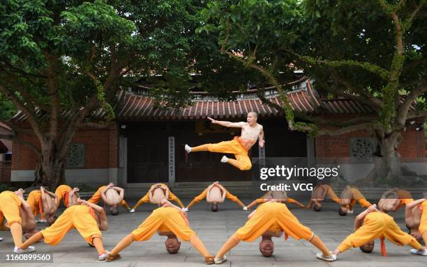 Monks practice martial art at the Quanzhou Shaolin Temple, also known as the South Shaolin Temple, on July 5, 2019 in Quanzhou, Fujian Province of...