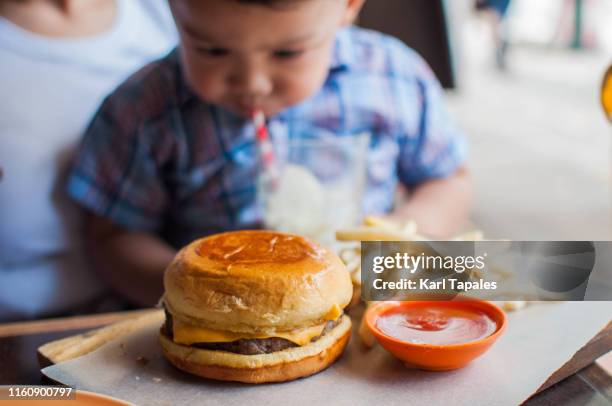 cheese burger and fries on a dining table - baby eat cheese bildbanksfoton och bilder