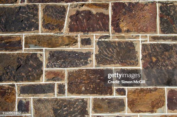 old stone wall on an historic building exterior - historic building stock pictures, royalty-free photos & images