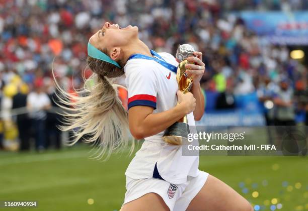 Julie Ertz of the USA plays air guitar with the trophy as she celebrates after the 2019 FIFA Women's World Cup France Final match between The United...