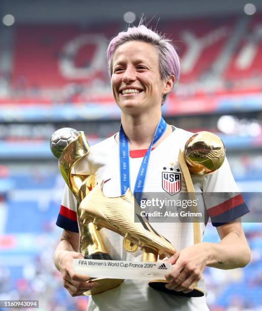 Megan Rapinoe of the USA celebrates with the FIFA Women's World Cup Trophy, the Golden Boot and The Golden Ball following the 2019 FIFA Women's World...