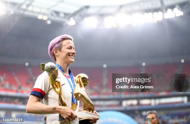 Megan Rapinoe of the USA celebrates with the FIFA Women's World Cup Trophy, the Golden Boot and The Golden Ball following the 2019 FIFA Women's World...