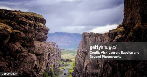 walking between the continents at thingvellir national park, iceland - tectonic stock pictures, royalty-free photos & images