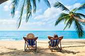 Couple relax on the beach enjoy beautiful sea on the tropical island