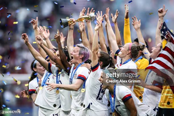 Megan Rapinoe of the USA lifts the FIFA Women's World Cup Trophy following her team's victory in the 2019 FIFA Women's World Cup France Final match...