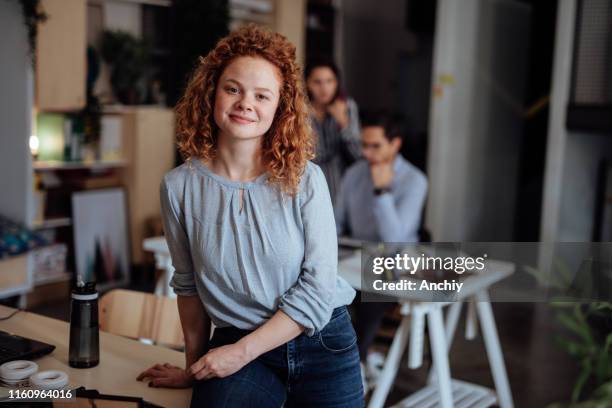 portrait of young woman in a busy modern workplace - respect stock pictures, royalty-free photos & images