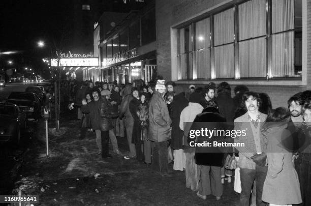 Scene from Dante's "Inferno?" It might be, with stem rising from a sidewalk grate, and a crowd lined up in 17-degree temperature waiting to see "The...