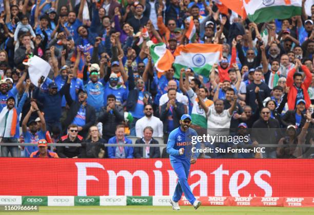 Dinesh Karthik of India celebrates after taking a catch to dismiss Jimmy Neesham of New Zealand during the Semi-Final match of the ICC Cricket World...