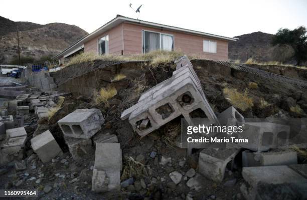 Cinderblocks from a toppled wall are scattered outside the Eldridge family home, which has been deemed uninhabitable due to structural damage from...