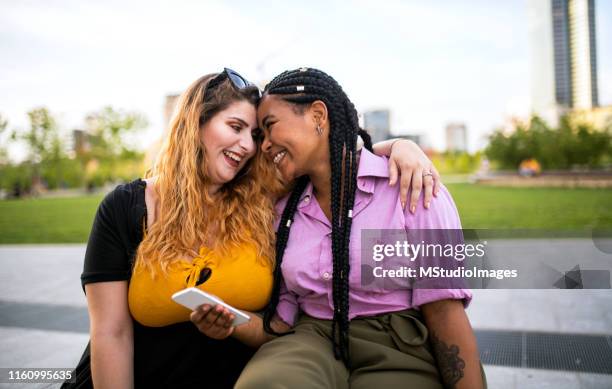 using mobile phone. - chubby black women stock pictures, royalty-free photos & images