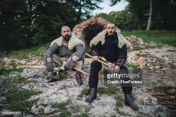 two vikings resting on a rock - viking stock pictures, royalty-free photos & images