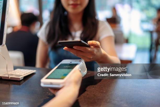 contactless mobile payment in cafe - contactless payment stock pictures, royalty-free photos & images
