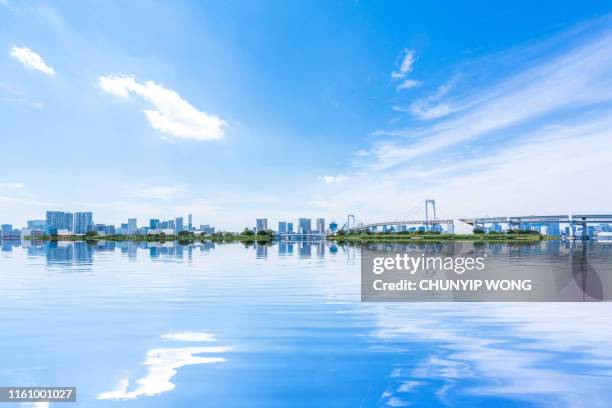 rainbow bridge seen from odaiba - city clear sky stock pictures, royalty-free photos & images