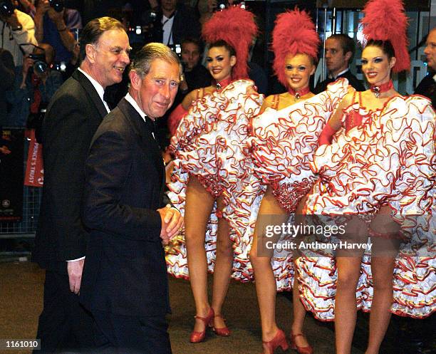 Britain's Prince Charles is greeted by Can-Can girls as he arrives at the premiere of "Moulin Rouge" September 3, 2001 in London, England.