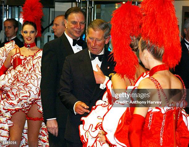 Britain's Prince Charles talks with Can-Can girls as he arrives at the premiere of "Moulin Rouge" September 3, 2001 in London, England.