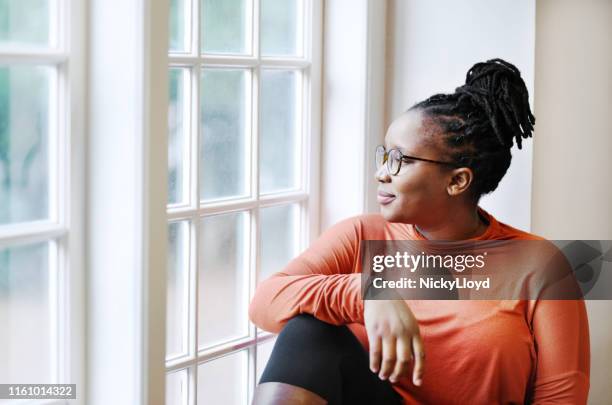 relaxing by the window - content stock pictures, royalty-free photos & images