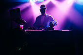 DJ Performing Music Set With Light Display
