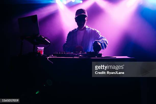 dj performing music set with light display - rapper stock pictures, royalty-free photos & images
