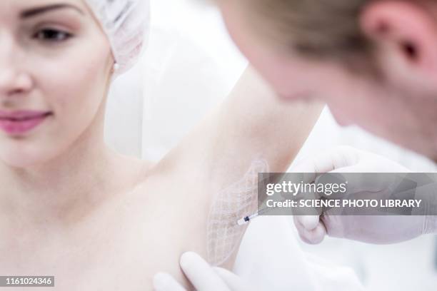 botox injection in underarm - needle injury stock pictures, royalty-free photos & images