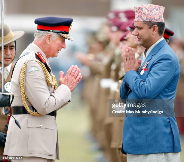 Prince Charles, Prince of Wales makes the traditional Namaste hand gesture as he visits the Battalion during the 25th anniversary year of their...