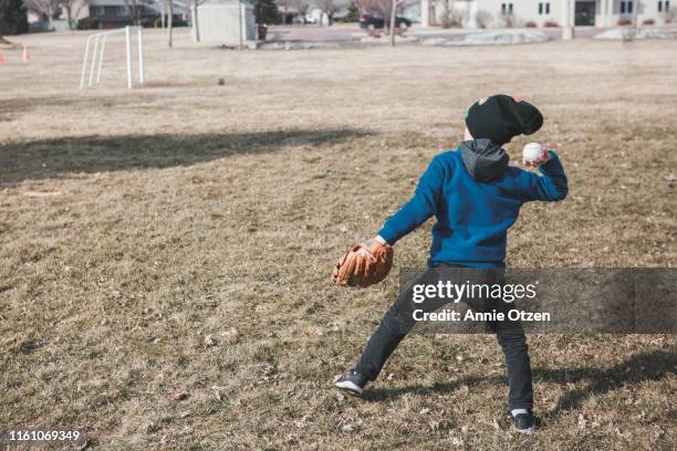 boy throwing baseball - baseball pitcher throwing stock pictures, royalty-free photos & images