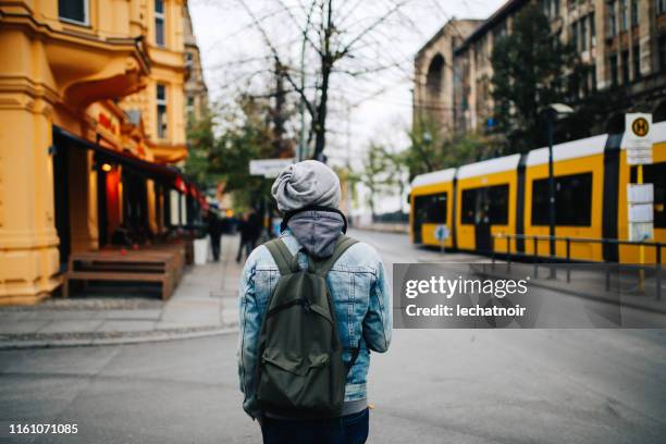 young man walking the streets of berlin - prenzlauer berg stock pictures, royalty-free photos & images