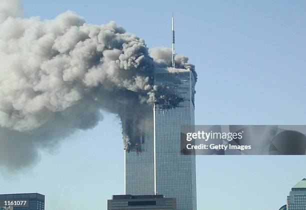 Smoke pours from the World Trade Center after being hit by two planes September 11, 2001 in New York City.